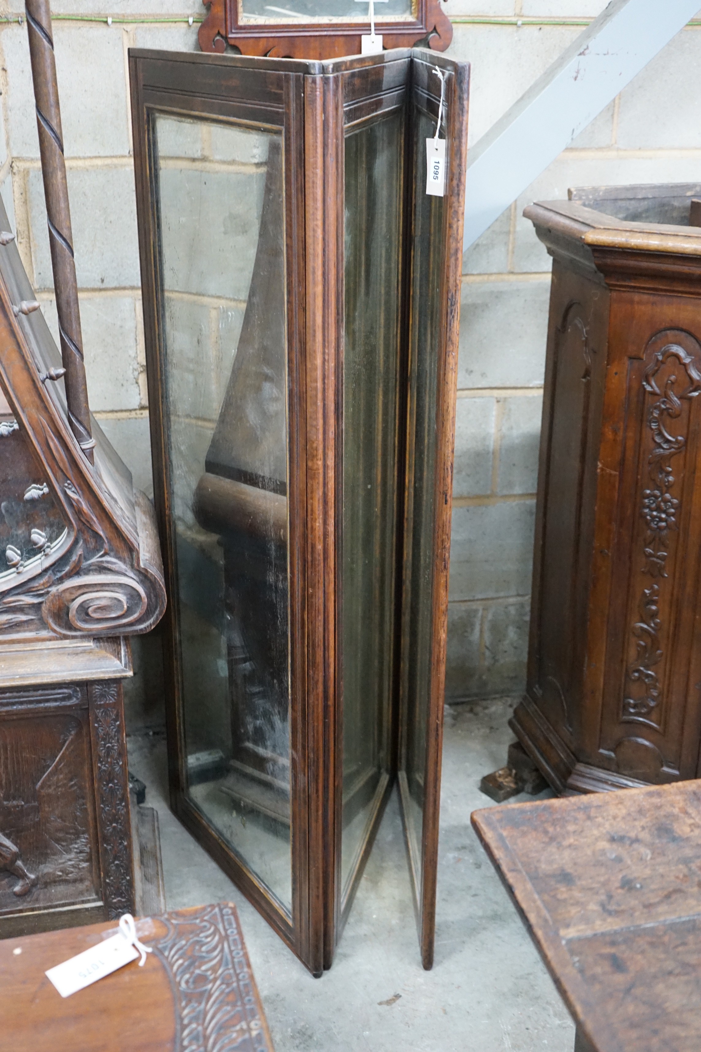 A late 19th century French mahogany mirrored three fold screen, each panel 53cms x 136cms.